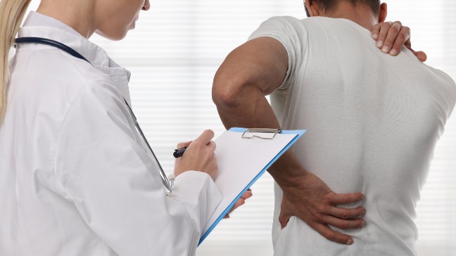 injured male patient who doesn't know what not to say to your workers' comp doctor during an IME